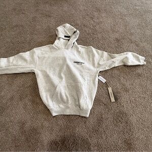 Essentials Light Gray Hoodie fits oversized